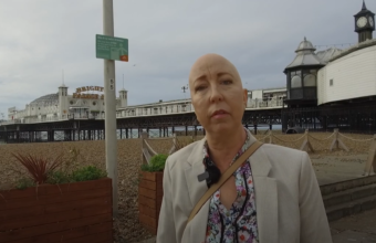 Image of Sarah Hurst, Sussex Cancer Fund ambassador, on Brighton Beach, photographer unkown