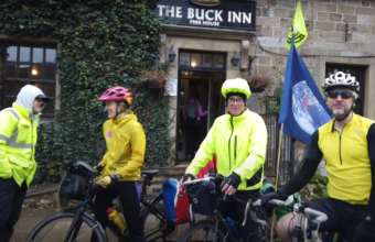 Image of 4 cyclists in front of a pub