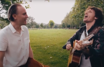 Image of musician Stefan Taylor in a park with a guitarist